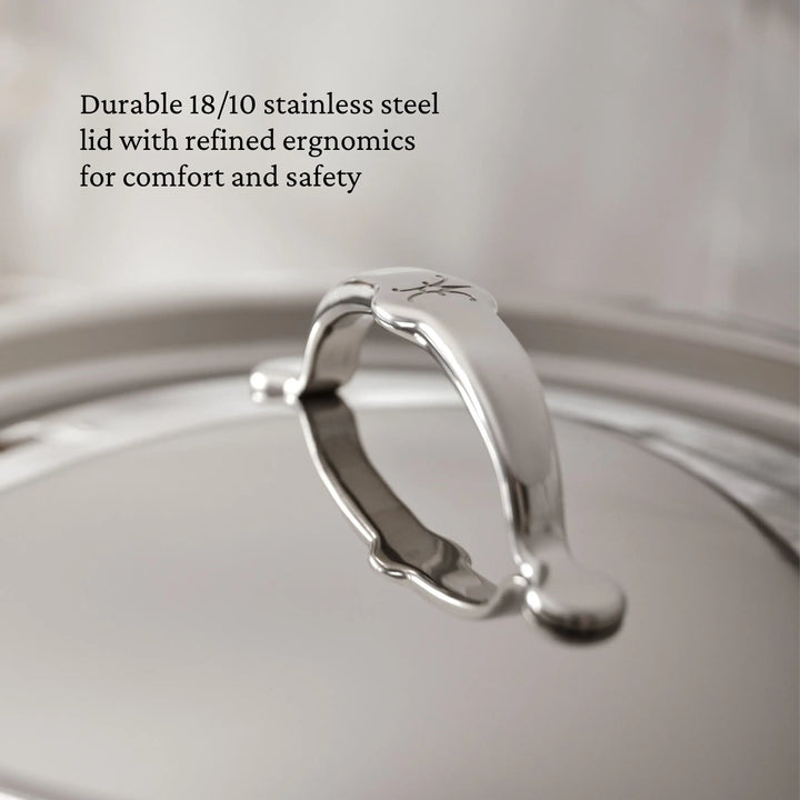 A close-up of the TITUM® Fusion 8-Quart Nonstick Stock Pot lid shows its polished 18/10 stainless steel, curved handle, and engraved emblem. Text reads: “Handcrafted in Italy for comfort and safety.”.