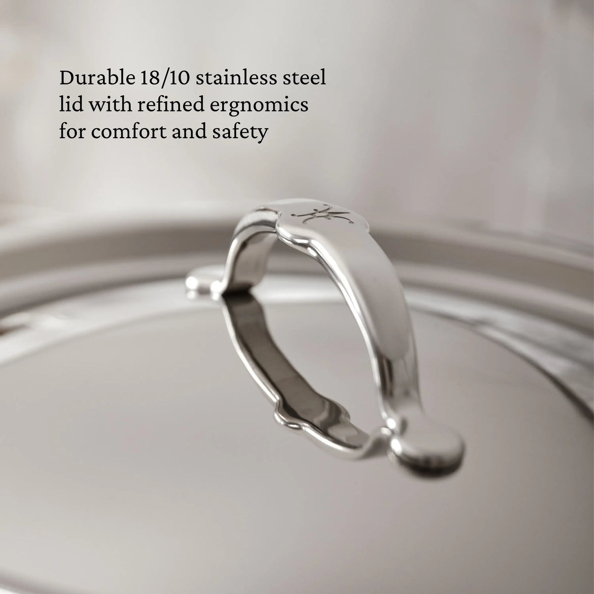 A close-up of the TITUM® Fusion 8-Quart Nonstick Stock Pot lid shows its polished 18/10 stainless steel, curved handle, and engraved emblem. Text reads: “Handcrafted in Italy for comfort and safety.”.