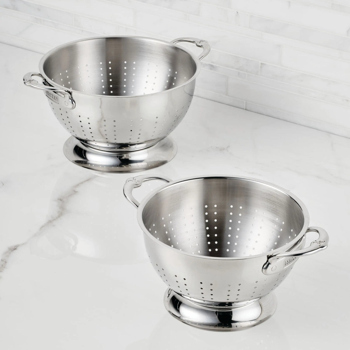 The Hestan Provisions Stainless Steel Colander Set, 2-Piece, features ergonomic handles and sturdy bases for style and everyday practicality—ideal for rinsing or draining on your kitchen countertop.