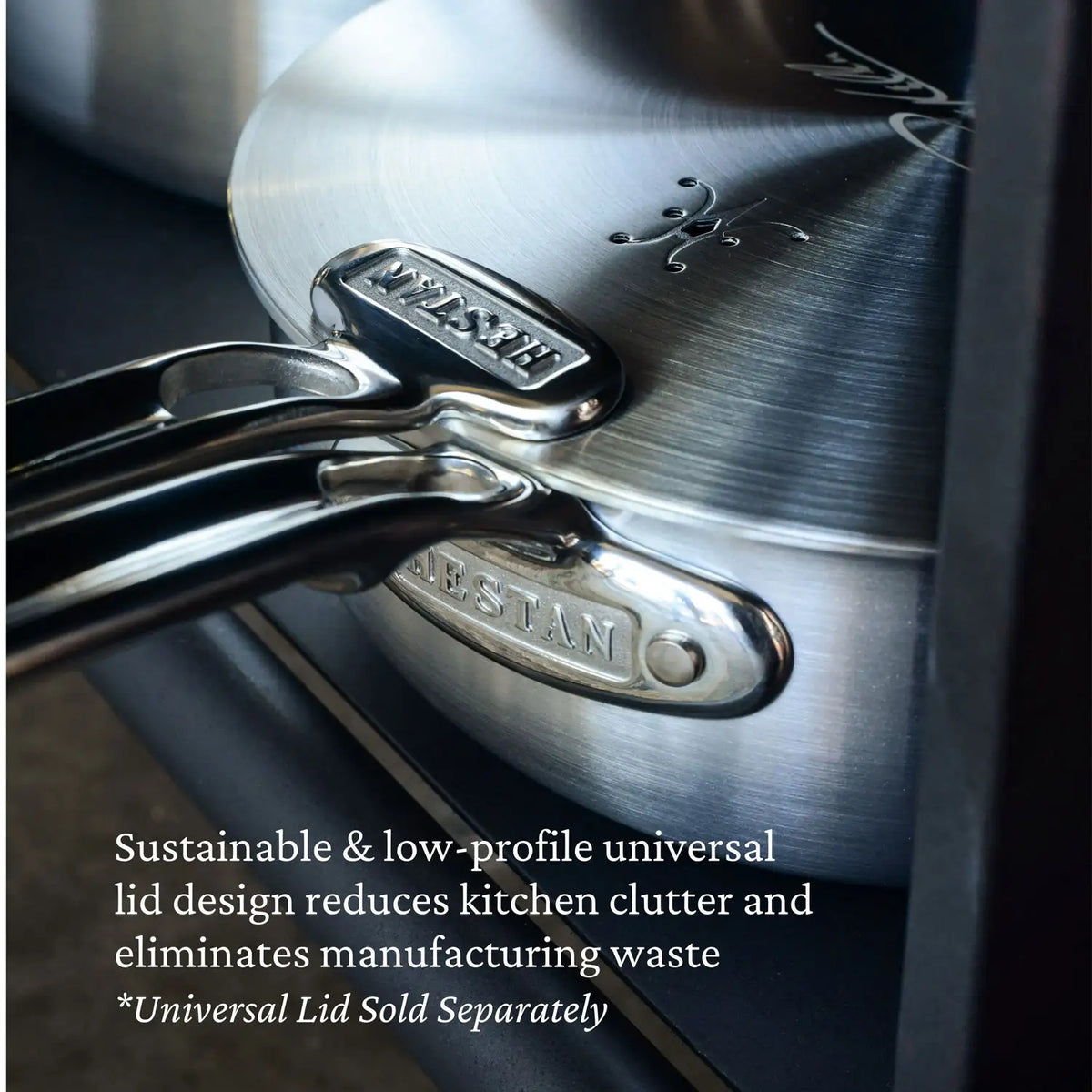 Close-up of Thomas Keller Commercial Clad Stainless Steel 2-Quart Saucier handles stacked, brand name embossed. Text overlay highlights a sustainable, low-profile universal lid to reduce kitchen clutter and boost professional cooking performance.