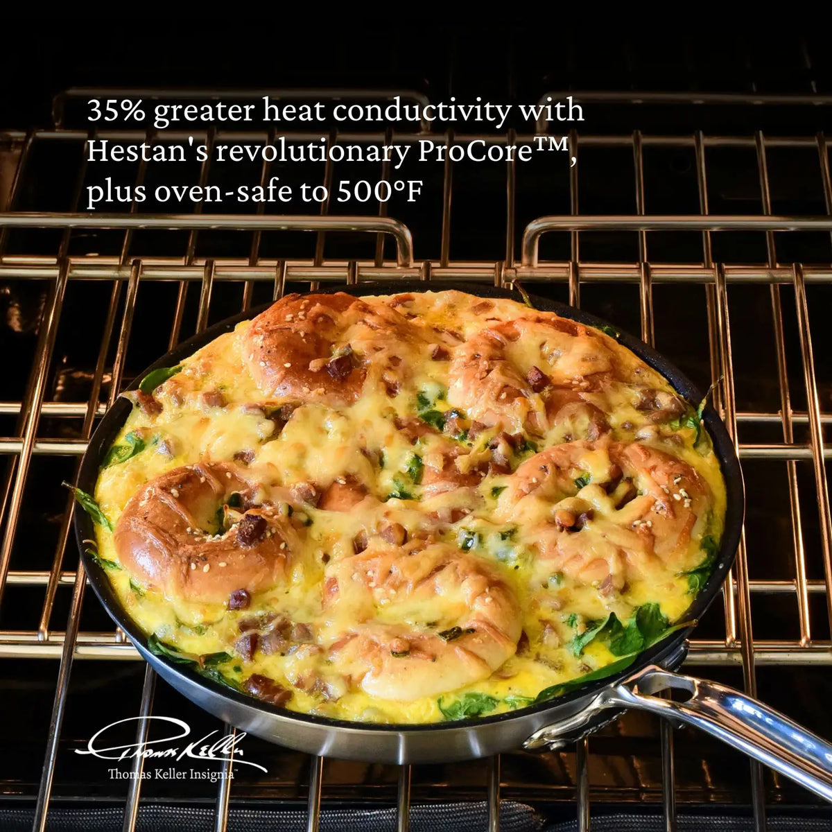 A Thomas Keller Commercial Clad Stainless Steel TITUM® Nonstick Skillet with a baked egg and bread dish sits on an oven rack. Text notes 35% more heat conductivity, oven-safe up to 500°F, and pro performance. A signature appears at the lower left.