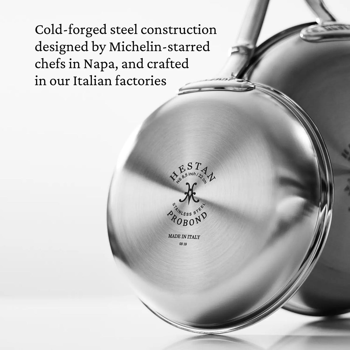 A close-up of two ProBond® Forged™ Professional Clad Stainless Steel TITUM® Nonstick Skillets shows their logo and Made in Italy engraving, with text highlighting expert design by Michelin-starred chefs.