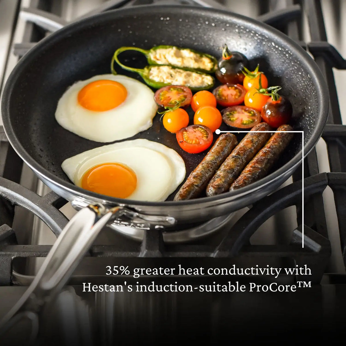 A ProBond® Forged™ Brushed Clad Stainless Steel TITUM® Nonstick Skillet cooks two sunny-side-up eggs, sausages, cherry tomatoes, and stuffed zucchini on a gas stove. Text at the bottom highlights its induction-suitable ProCore™ heat conductivity.