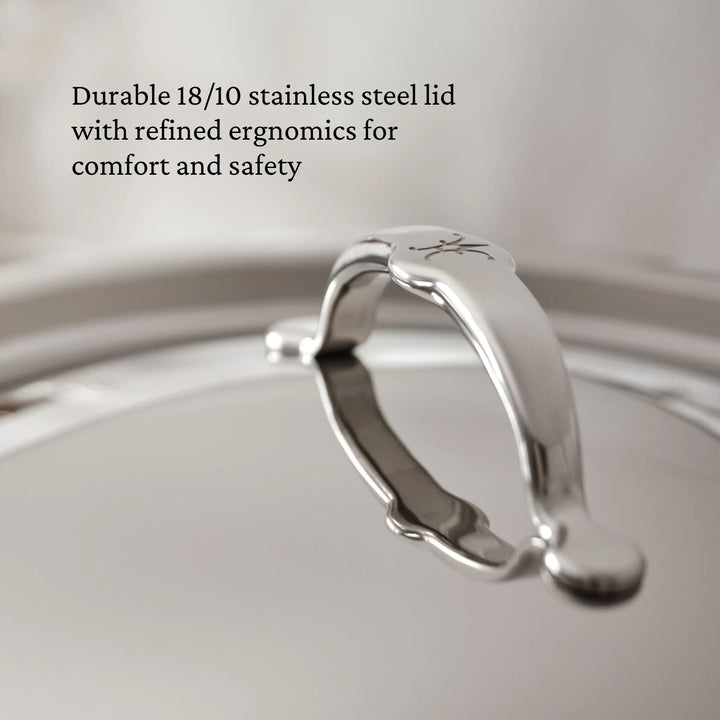 Close-up of the ProBond® Luxe™ Professional Clad Stainless Steel Soup Pot lid with a sturdy, curved handle, showcasing Italian craftsmanship. Overlaid text highlights durability and ergonomic design for comfort and safety.