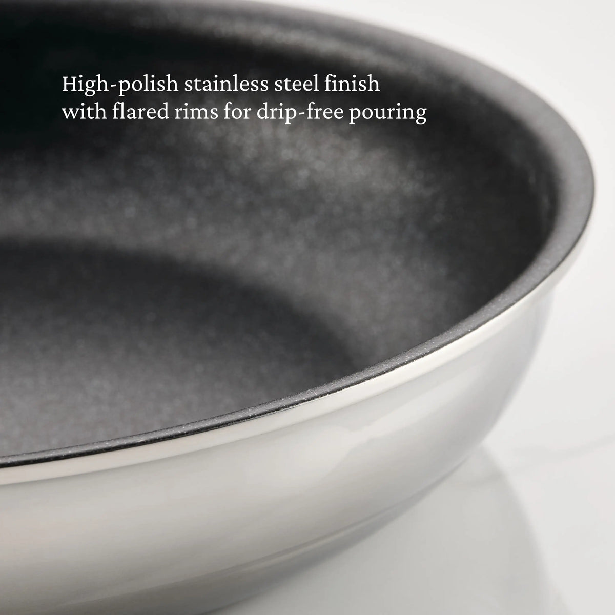 Close-up of ProBond® Luxe™ Polished Clad Stainless Steel Skillets with TITUM® Nonstick. Image text: High-polish stainless steel finish and flared rims ensure drip-free pouring.