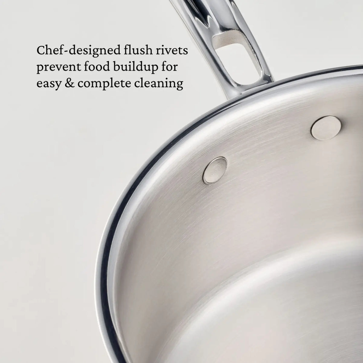 A close-up of the CopperBond Aura™ Polished Copper 2-Quart Saucier with Lid reveals flush rivets securing the handle, with accompanying text highlighting that this professional-grade design helps prevent food buildup for effortless cleaning.