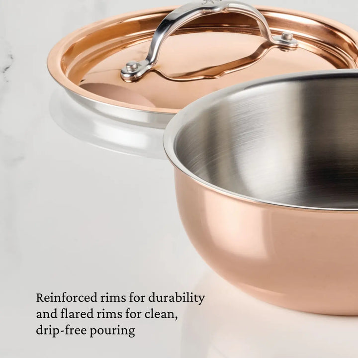 The CopperBond Aura™ Polished Copper 2-Quart Saucier with Lid is displayed on a white surface. Text in the image highlights its reinforced rims for durability and flared rims for drip-free pouring, making this saucier an essential piece of professional cookware.