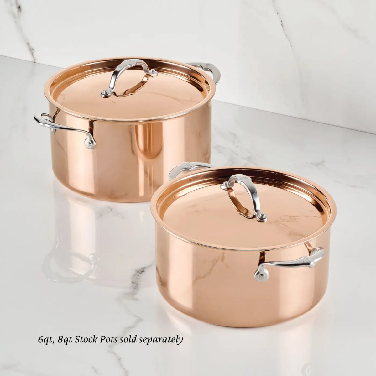 Two gleaming Polished Copper Stock Pots with Lids from CopperBond Aura™ rest on a white marble surface, highlighting the elegance of professional copper cookware. Each pot features a durable stainless steel interior and stylish silver handles, available in 6qt and 8qt sizes (sold separately). The text in the image reads, “6qt, 8qt Stock Pots sold separately.”.