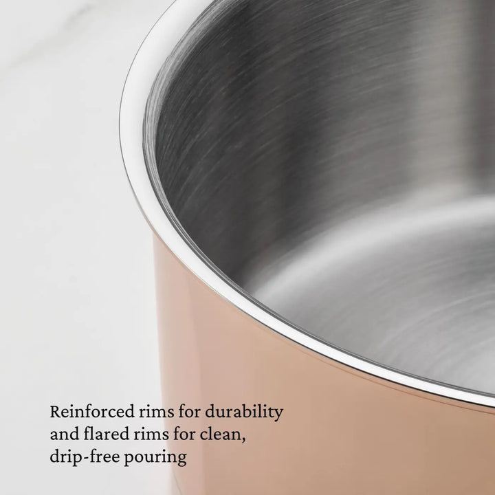 Close-up of the CopperBond Aura™ Polished Copper Stock Pot with Lid, featuring a gleaming copper-colored exterior and a reinforced, flared rim. This professional-quality cookware offers a robust stainless steel interior for lasting performance and drip-free pouring. Text in the corner highlights the rim’s durability and thoughtful design, set against a light, solid background.