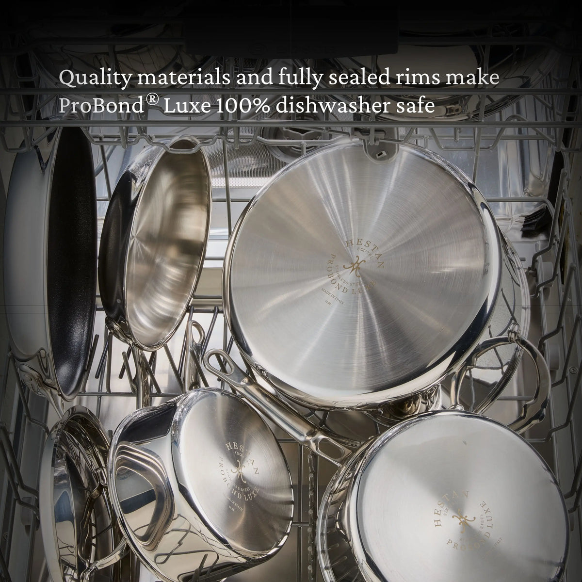 Open dishwasher filled with gleaming Polished Clad Stainless Steel Signature Set, 7-Piece by ProBond® Luxe™, all placed upside down on the racks. Top text: “Quality materials and sealed rims make ProBond® Luxe™ 100% dishwasher safe.”.