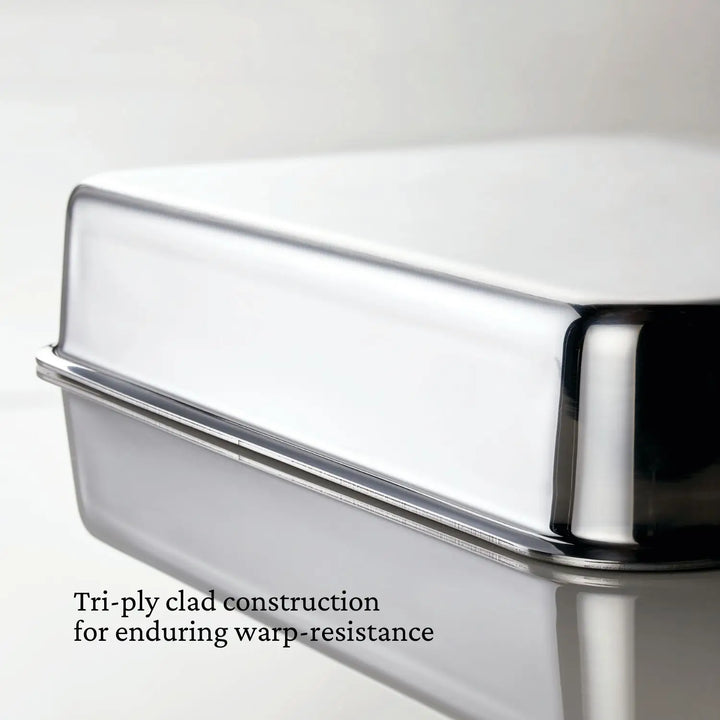 A close-up of the Hestan OvenBond Tri-ply Rectangular Baker's smooth corner highlights its tri-ply clad construction for lasting warp-resistance.