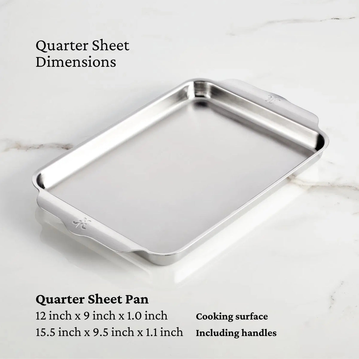 The Hestan OvenBond Tri-ply 5-Piece Set quarter sheet pan, made of durable stainless steel, rests on white marble. Dimensions shown: 12 x 9 x 1 in. cooking area; 15.5 x 9.5 x 1.1 in. with handles.