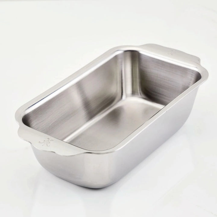 The Hestan OvenBond Tri-ply Stainless Steel 1-Pound Loaf Pan, featuring rounded corners and two small handles, is shown on a plain white surface.