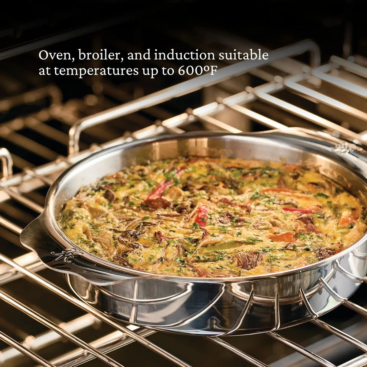 A Hestan OvenBond 9-inch Round Baker filled with vegetable frittata sits on an oven rack. Text above reads, "Oven, broiler, and induction safe up to 600°F.