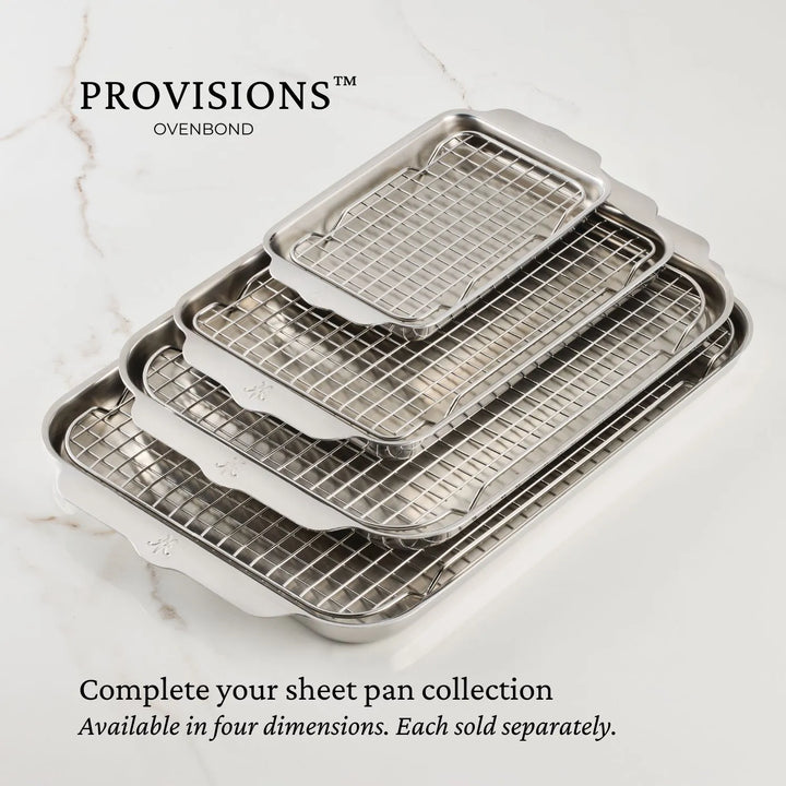 Four Hestan OvenBond Tri-ply Mini Eighth Sheet Pans with matching racks are nested on a marble surface. Text reads: “Complete your collection. Available in four sizes, including the mini eighth sheet pan. Each sold separately.”.