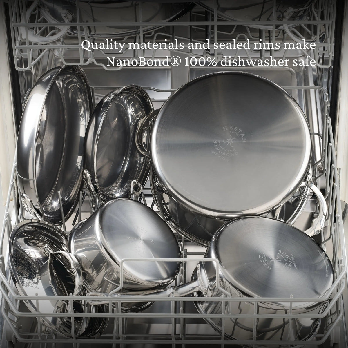 Open dishwasher filled with clean stainless steel pots and pans, including a sleek NanoBond Titanium Rondeau with Lid; text above reads, "Quality materials and sealed rims make NanoBond 100% dishwasher safe.