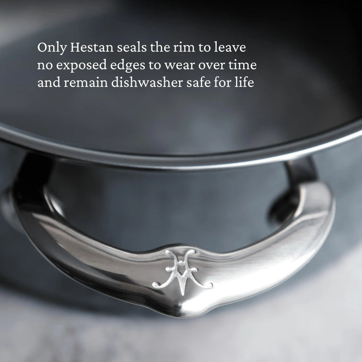 Close-up of a stainless steel handle with engraved logo. Text: “Only NanoBond Titanium Rondeaus with Lids seal the rim—no exposed edges to wear, and they stay dishwasher safe for life.”.