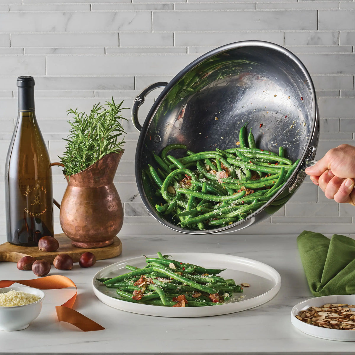 Someone pours green beans with cheese and bacon from a NanoBond Titanium Chef&
