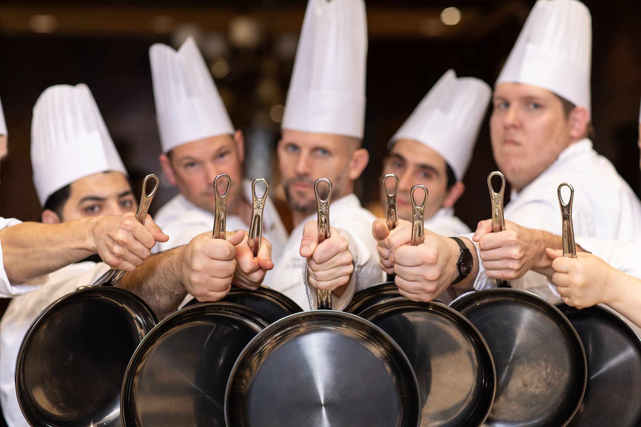 Chefs holding Hestan Culinary skillets